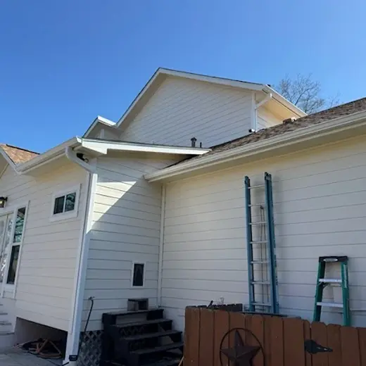Two-story home with freshly painted light beige siding.